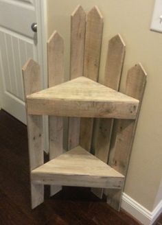 a wooden chair made out of pallet boards sitting on top of a hard wood floor