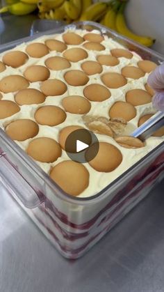 a person cutting into a dessert in a plastic container