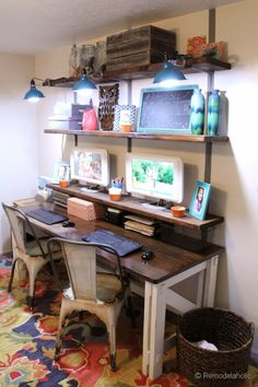 a home office with two desks and shelves on the wall