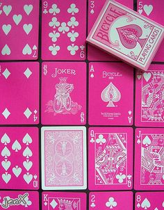 pink playing cards with white hearts and jokers on the sides, all in different shapes and sizes