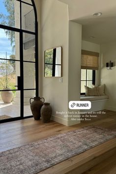 a living room filled with furniture and large windows