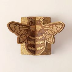 a wooden block with a bee on it