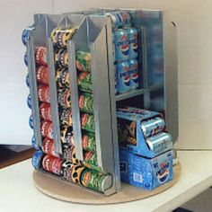 a display case filled with cans of soda and soft drinks on top of a counter