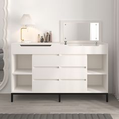 a white dresser with mirror and lights on it