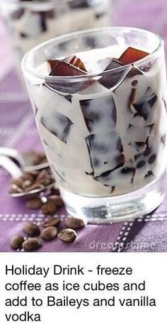 a glass filled with ice cream sitting on top of a table next to coffee beans