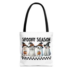 a white tote bag with three dogs wearing halloween costumes