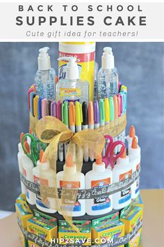 a stack of crayons and markers on top of each other with a bow