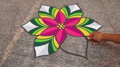 a person holding a colorful flower shaped kite