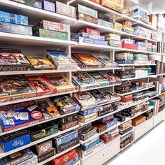 a store filled with lots of different types of cards and games on shelves next to each other