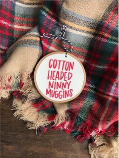 a wooden sign that says, cotton headed tiny mugins on it's side