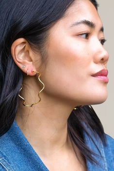 make a statement with these wavy gold hoop earrings. their contemporary design and timeless appeal make them a must-have accessory for your jewelry collection. whether you're dressing up for a special occasion or adding a touch of elegance to your everyday look, these hoops are the perfect choice. 18K gold plated nickel and lead free waterproof size: 3.75" - 3.90" diameter made with ethically sourced materials made in the usa all jewelry is final sale Modern Twist Gold Plated Hoop Earrings, Modern Twist Gold-plated Hoop Earrings, Romper With Skirt, Gold Hoop, Gold Hoop Earrings, Hat Hairstyles, Handbags On Sale, Everyday Look, Sale Items