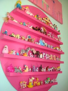 a pink shelf filled with lots of toy figurines