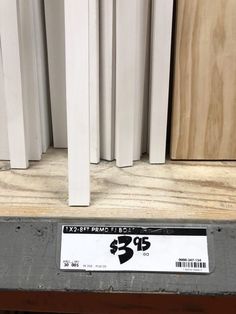 a shelf with some white and wood panels on it