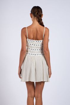 Get ready to turn heads in our Audrey White Dot Ribbon Trim Mini Dress! It's the coolest replay of white polka dot dress in a coquette twist. White polka dot fabric flows effortlessly in this flare silhouette. Features a tiered lace ribbon trim and a ribbon tie neckline. Sleeveless design with adjustable cami straps, you'll feel comfortable and flirty all day long. Pair it with leather boots for an edgy look. Back hidden zipper/closure. DETAILS & FIT 100% Rayon Lining: Polyester. For Best Result Polka Dot Mini Sundress For Spring, Polka Dot Mini Dress With Ruffle Hem, Polka Dot Tiered Summer Dress, Summer Polka Dot Tiered Dress, Summer Tiered Polka Dot Dress, Polka Dot Ruffled Sundress Mini Dress, Polka Dot Ruffled Sundress, Polka Dot Ruffled Mini Dress For Beach, Polka Dot Mini Dress With Ruffles For Beach