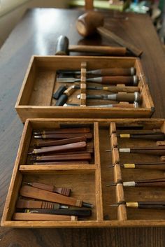 two wooden trays filled with different types of tools