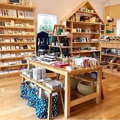 the inside of a store with lots of books and other items on display in it