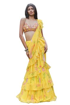 Yellow ruffle pre-draped saree with an attached cancan and floral print. Comes with a padded blouse with mirror and cowrie hand embroidery. - Aza Fashions Summer Bollywood Pre-draped Saree, Summer Lehenga For Reception With Traditional Drape, Summer Saree Sets With Ruffles, Summer Georgette Sets With Ruffles, Summer Georgette Pre-draped Saree For Reception, Summer Party Choli With Ruffles, Fitted Sleeveless Ruffle Choli, Summer Traditional Georgette Pre-draped Saree, Traditional Pre-draped Saree With Ruffles For Summer