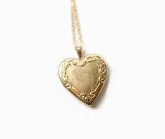 Vintage Gold Heart Locket Necklace. This gold filled locket has the name Mom engraved on the front of locket in cursive, along with an image of a flower. Embossed edging around the heart. The locket opens and closes easily and securely. The gold filled chain was added by me, not vintage. Circa 1960s Marked: 14k GF, PPO Measurements: Locket is 1 inch in height Chain- 18 inches length Very good condition. Gold Etched Locket Necklace, Vintage Etched Jewelry For Commemoration, Heirloom 14k Stamped Locket Necklace Keepsake, Heirloom 14k Stamped Locket Necklace For Keepsake, Vintage Stamped 14k Locket Necklace For Wedding, Vintage Necklace With Engraving Option For Keepsake, Vintage 14k Stamped Locket Necklace For Wedding, Vintage 14k Stamped Necklace For Commemoration, Gold Etched Locket Necklace For Memorial