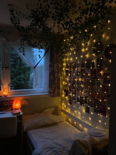 a bedroom with lights on the wall and a bed in front of a large window