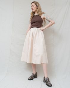 [she loved the sound of summer rain tapping against her window]Meet Emma, the embodiment of effortless style! This handmade full skirt radiates cozy minimalist chic vibes. Its stretchy elastic waist ensures unrestricted comfort, making it perfect for any day of the month. Crafted from stunning, thick linen fabric, Emma offers a luxurious feel you'll simply adore. Dress it up with boots and a blouse for a date, or keep it casual with sneakers and a tee for running errands. Heading to the office? Summer Feminine Bottoms With Pleated Waist, Feminine Summer Bottoms With Pleated Waist, Feminine Pleated Waist Bottoms For Summer, Feminine Bottoms With Pleated Waist For Summer, Modest Relaxed Fit Bottoms For Spring, Everyday Spring Lined Skirt Bottoms, Spring Everyday Midi Skirt, Summer Beige Bottoms With Pleated Waist, Everyday Cotton Skirt For Spring