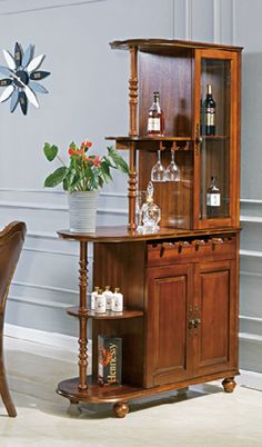 a dining room table with chairs and a wine cabinet