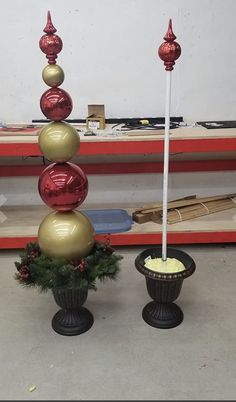 two vases with balls and candles on them