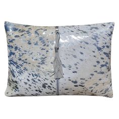 an animal print pillow with a tasselled fringe on the front and back side