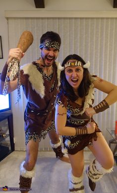 two people dressed in costumes posing for a photo