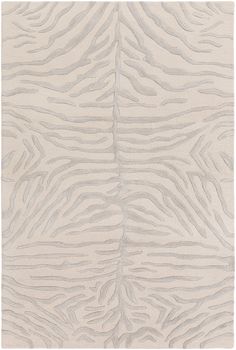 a white rug with wavy lines in the middle and an animal print pattern on it