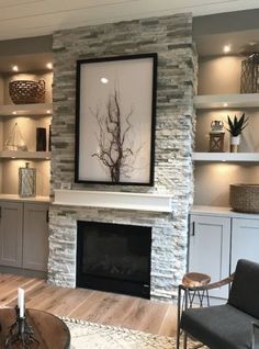 a living room filled with furniture and a fire place in front of a stone fireplace