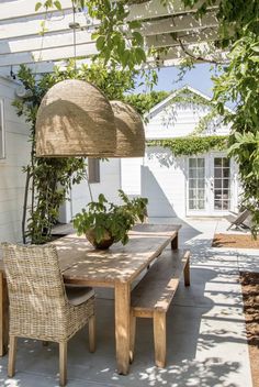 a wooden table sitting under a shade umbrella