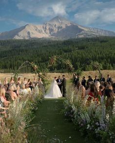 a couple getting married in front of a mountain