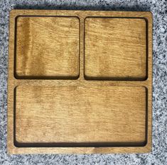 two wooden trays sitting on top of a counter