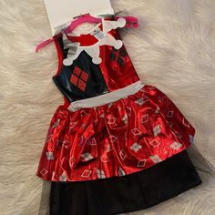 Girls Harley Quinn Costume. Perfect For Halloween A Themed Party Or To Play Dress Up. Includes Printed Dress, Headband And Two Cuffs. Brand New With Tags Attached. Various Sizes Girls Harley Quinn Costume, Harley Quinn Kids Costume Children, Harley Quinn Costume, Harley Quinn, Kids Costumes, Playing Dress Up, Dress Up, Brand New, Color