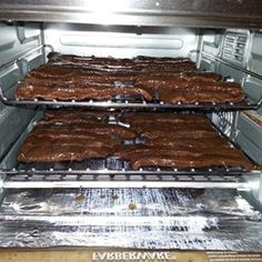 two racks of meat cooking in an oven