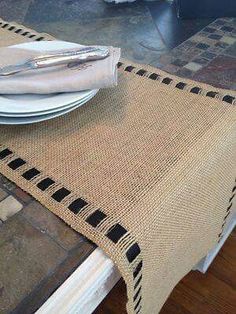 a place setting with plates and silverware on a table