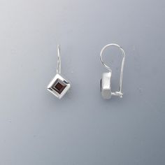 Brilliant faceted garnet, rich with natural color. Rim set with open back for a secure fit and stunning radiance. Cast sterling silver packaged with anti-tarnish paper to maintain long-lasting shine. Faceted Sterling Silver Earrings Fine Jewelry, Modern Silver Earrings With Birthstone, Silver Garnet Birthstone Earrings, Silver Garnet Earrings For Formal Occasions, Modern Silver Birthstone Earrings, Silver Faceted Fine Jewelry Earrings, Faceted Silver Fine Jewelry Earrings, Fine Jewelry Silver Faceted Earrings, Faceted Sterling Silver Earrings For Formal Occasions