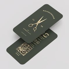 two green business cards with gold scissors on them