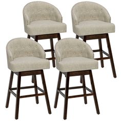 four beige upholstered barstools with wooden legs