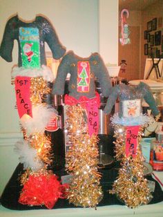 two christmas sweaters are on display in front of other decorations and gifts at a party