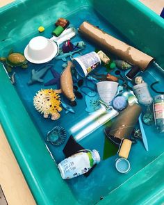 a blue tray filled with lots of different types of toys and items on top of it