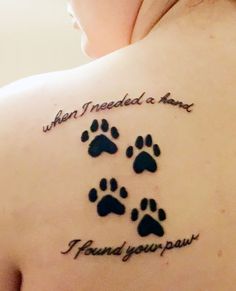 a woman with a tattoo on her back that says, when i needed a name, i found your paw