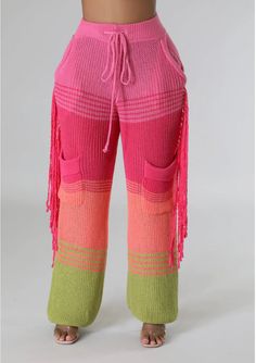 This stylish pair of knit pants will make a bold fashion statement. Featuring a fringe detail and bright neon colors, this piece is perfect for the woman who loves to stand out. Model wearing a small