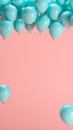 blue balloons floating in the air against a pink background