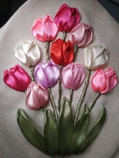 a bunch of flowers that are on top of a pillow