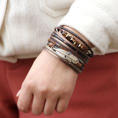 Multi-strand PU leather bracelet. Great quality! Connects with a plated bar that is magnetic. We really love this bright but deep brown imitation leather. The variety of colors and textures in this bracelet make it a perfect match for a wide range of outfits. We are positive you'll love this bracelet! We also have it available in buckskin and gray. Trendy Brown Bracelet As Fashion Accessory, Trendy Brown Bracelets As Fashion Accessory, Elegant Brown Leather Wrap Bracelet, Trendy Brown Leather Bracelet, Trendy Brown Wrap Bracelet Gift, Bohemian Wrap, Leather Bangle, Boho Feathers, Gold Feathers