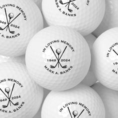 many white golf balls with the words loving memory on them