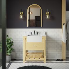 a bathroom with a sink, mirror and rug on the floor in front of it