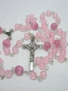 "This pink agate Lutheran rosary was made with 6mm light pink agate beads and 8mm matte cat's eye rounds. I hand turned the silver plated wires. The connector and cross are pewter. The rosary measures about 21\" around with a 5 inch cross drop. This rosary will be slipped into a velvet bag and shipped in a bubble mailer." Pink Healing Rosary With 8mm Beads, Handmade Pink Rosary For Healing, Pink Rosary With 8mm Round Beads, Pink Rosary Bracelet With Round Beads For Healing, Pink Spiritual Rosary Bracelet With 8mm Beads, Handmade Pink Rosary Bracelet For Healing, Pink 8mm Bead Spiritual Rosary Bracelet, Pink Beaded Spiritual Rosary, Pink 8mm Beads Rosary Bracelet