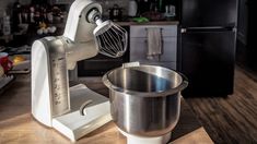 an electric mixer sitting on top of a wooden counter